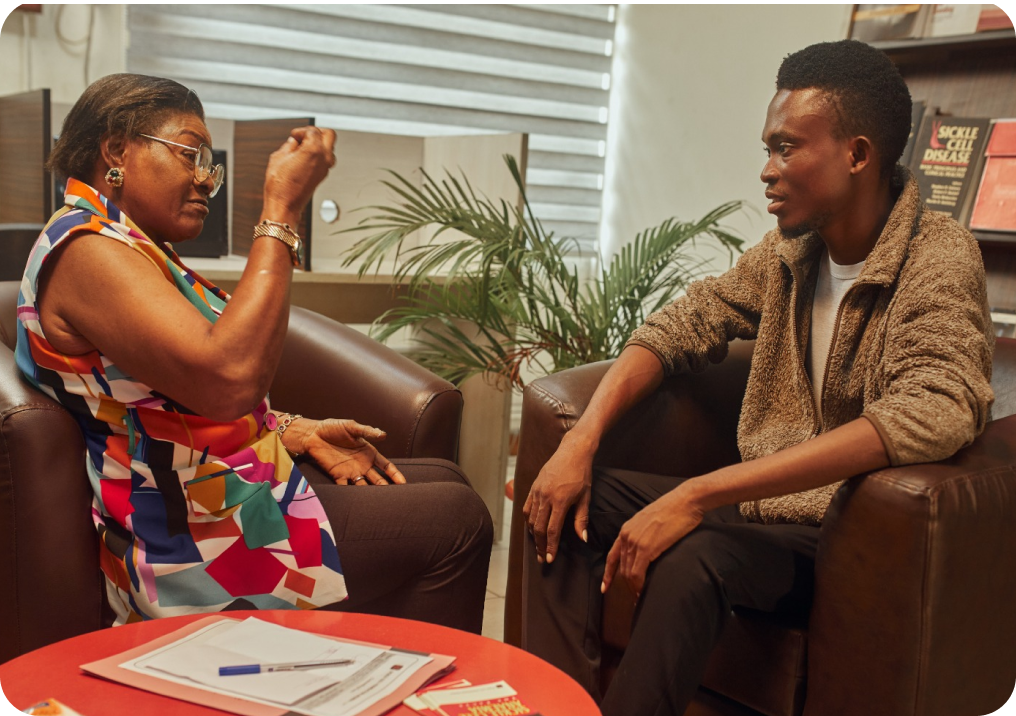 A genetic counsellor speaking with a man at SCFN.