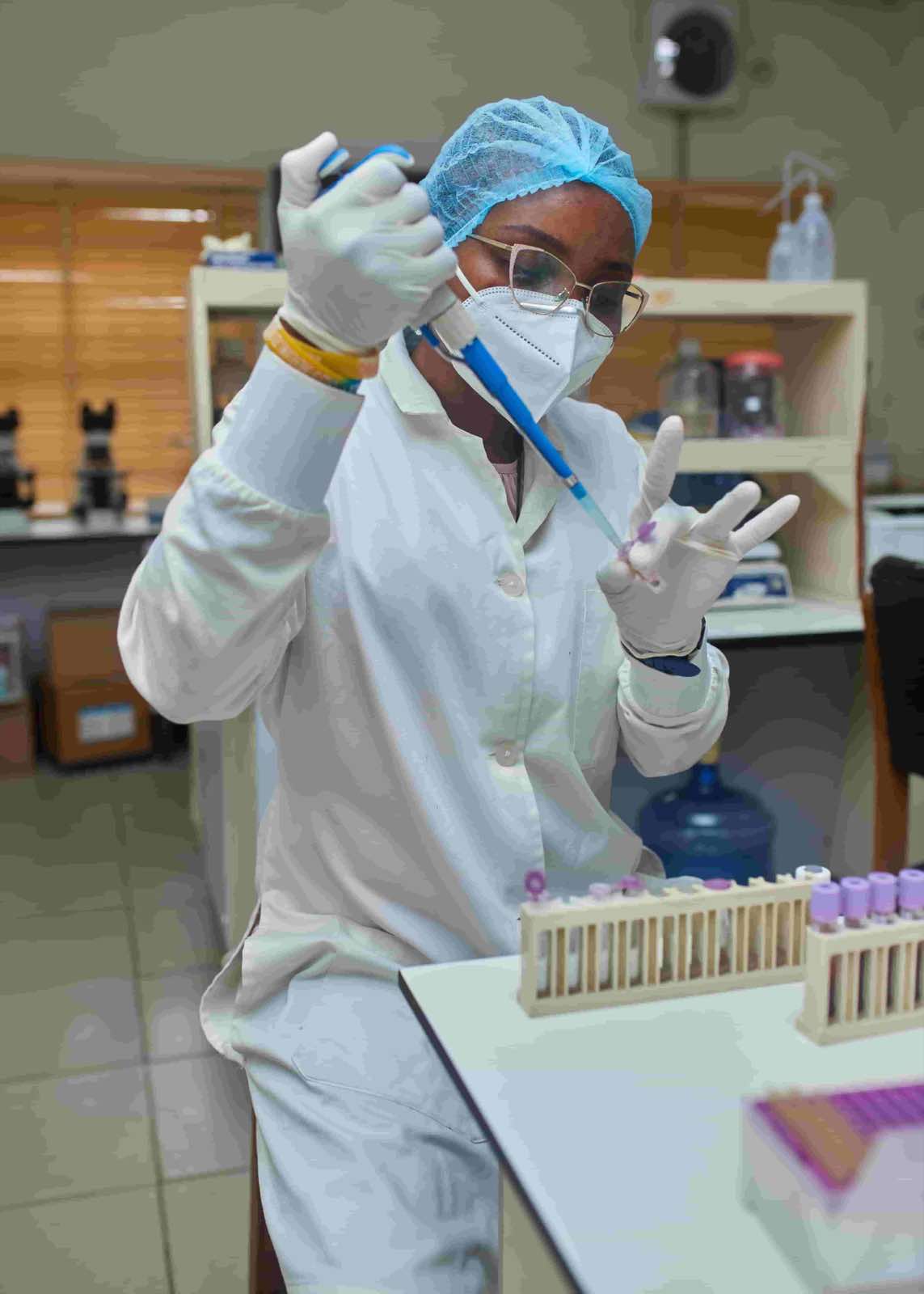 Lab specialist performing blood analysis procedures.