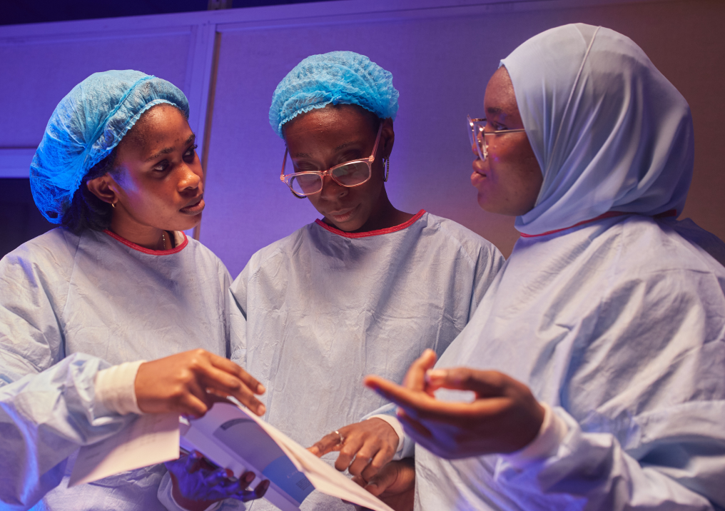Three clinicians discussing a prenatal diagnosis procedure.