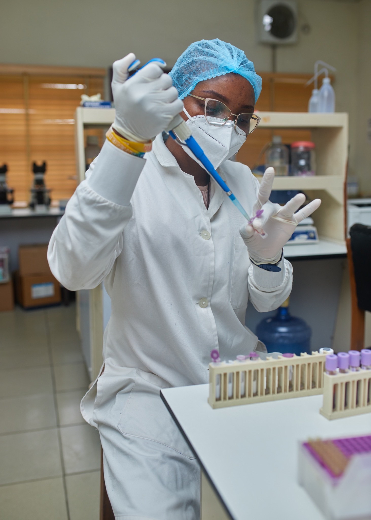 Clinical specialist preparing treatment materials in a laboratory setting.