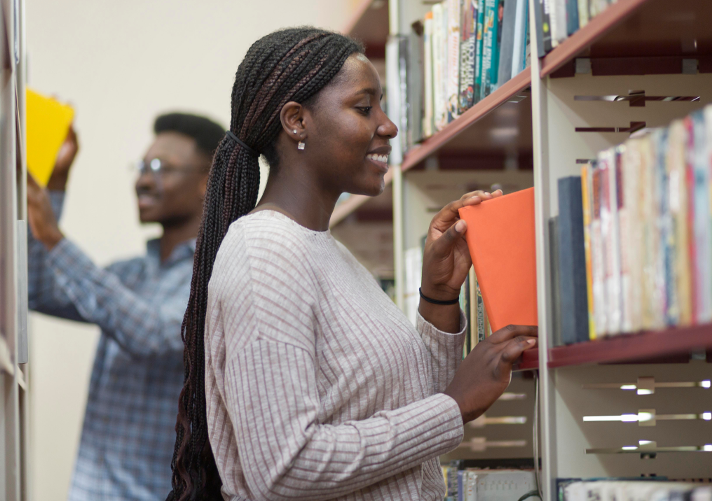 Students choosing books in the Resource Centre library